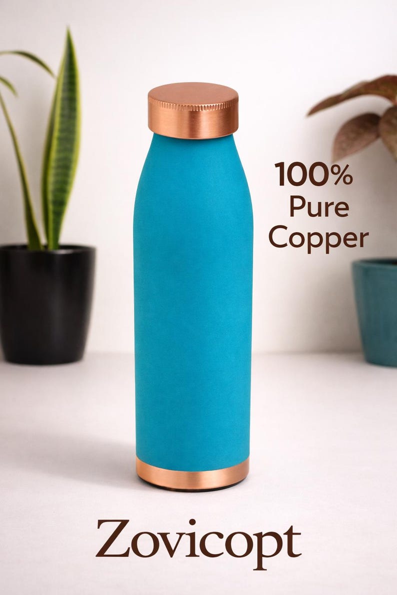 May include: A turquoise water bottle with a copper lid and base. The bottle has the text "100% Pure Copper" and the brand name "Zovicopt". The bottle is cylindrical and appears to be made of metal.