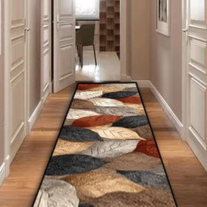 May include: A rectangular hallway rug with a leaf pattern in shades of brown, black, and rust. The rug is placed on a wooden floor, creating a warm and inviting entryway. The rug's design adds a touch of nature-inspired decor.