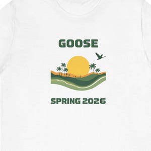 May include: White t-shirt with a graphic design featuring a yellow sun, palm trees, and a flying bird. The word "GOOSE" is above the image, and "SPRING 2026" is below it. The shirt is made of a soft material.