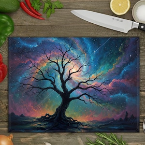 May include: Rectangular tempered glass cutting board featuring a vibrant, colorful illustration of a tree against a nebula background. The artwork showcases a dark tree silhouette with intricate branches, set against a backdrop of swirling blues, purples, and oranges.