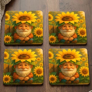 May include: Set of four square coasters featuring a whimsical gnome wearing a sunflower hat. The gnome is seated in a field of sunflowers, with a wooden fence in the background. The coasters have a warm, inviting color palette.