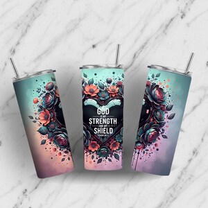 May include: Three stainless steel tumblers with lids and straws. Each tumbler features a floral design with a heart-shaped centerpiece and the text "GOD IS MY STRENGTH AND MY SHIELD". The tumblers have a gradient color scheme.