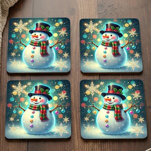 May include: Set of four square coasters featuring a whimsical snowman design. Each coaster showcases a snowman with a black top hat, a colorful scarf, and a carrot nose, set against a snowy, festive background with snowflake and ornament details.