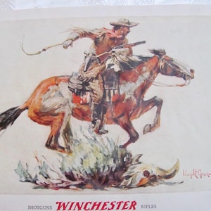 May include: Vintage Western-themed print featuring a cowboy on horseback, holding a rifle and whip. The horse is jumping over a skull and brush. The print has a sepia tone with the Winchester Rifles logo at the bottom.