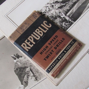 May include: A brown and black pamphlet with the text "REPUBLIC" in large white letters. The pamphlet advertises "High Speed Straight Shank Twist Drills" made by "ATID" in the USA. The pamphlet is for Republic Drill & Tool Co., with factories in New York, Chicago, and Los Angeles.