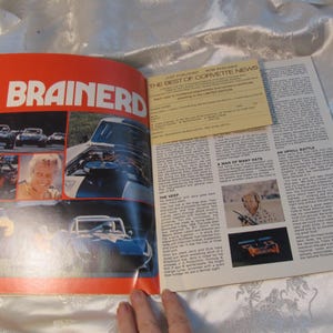 May include: Open magazine pages featuring the word "BRAINERD" in large orange text. The left page displays car images and a portrait. The right page has text and a yellow insert titled "BEST OF CORVETTE NEWS".