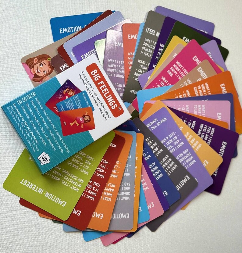 May include: A set of colorful Big Feelings cards for children, featuring illustrations and prompts about emotions. The cards are fanned out, with the box visible, displaying the title and purpose of the cards.