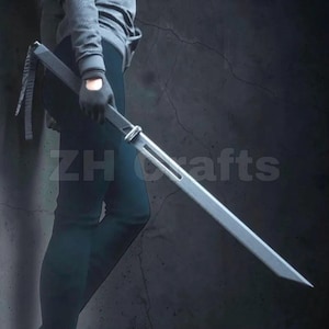 May include: A long, matte grey sword with a straight, double-edged blade featuring a central cutout slot near the hilt. The sword has a simple, angular crossguard and a dark handle. The text ZH crafts is visible in the background behind the blade.