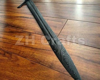 May include: A double-edged sword featuring a dark, patterned Damascus steel blade with a visible wavy grain. The sword has a straight crossguard and a dark, textured handle. The text ZH Crafts is overlaid across the center of the blade.