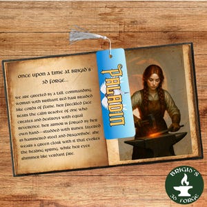 May include: A bookmark with a blue background and the word "PALADIN" in yellow. The bookmark is attached to a book with text and an illustration of a woman blacksmith. The book is open on a wooden surface.