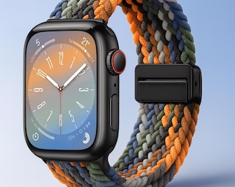Puede incluir: Un reloj inteligente negro con una colorida correa trenzada en tonos naranja, verde, azul y gris. La esfera del reloj muestra la hora y otras métricas. La correa se asegura con un cierre negro.