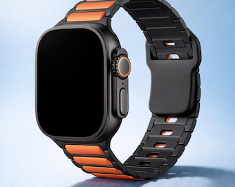 May include: A black smartwatch with an orange and black band. The watch face is black, and the band features orange links alternating with black metal links. The watch has a sleek, modern design, suitable for everyday wear.
