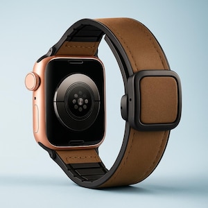 May include: A rose gold smartwatch with a brown leather band and black accents. The watch face is black, and the band features a square buckle. The watch is displayed against a light blue background.