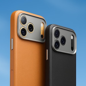 May include: Close-up of two smartphone cases. One is tan leather with a silver camera frame, the other is black leather with a silver camera frame. Both cases have a sleek, modern design and a blue background.