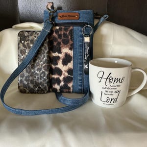 May include: Denim crossbody bag with a leopard print panel, a matching phone case, and a white mug. The mug has the text "Home As for Me and My house We will Serve the Lord". The bag has a leather tag that says "Dear Dimes".