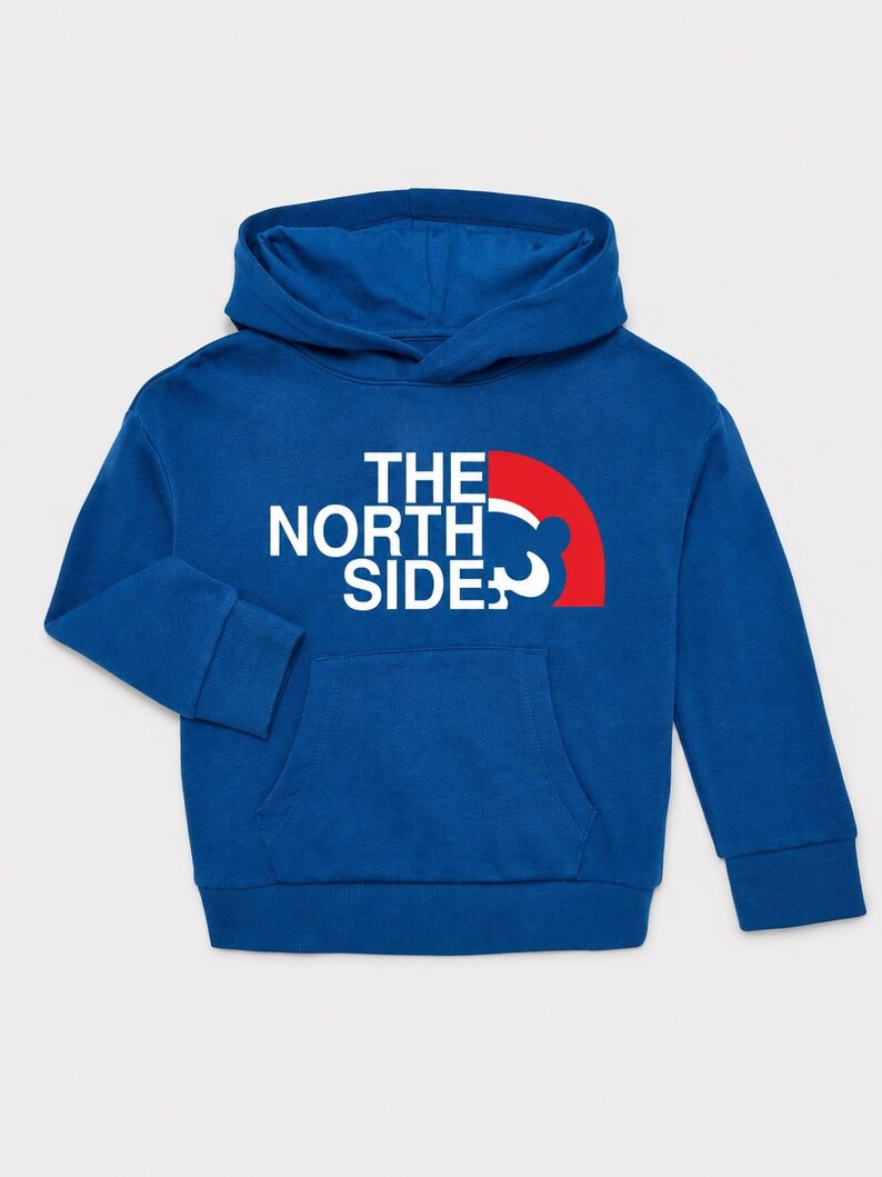 May include: A blue hoodie with a kangaroo pocket and a hood. The front features the text "THE NORTH SIDE" in white, with a red and white graphic. The hoodie is made of a soft material.