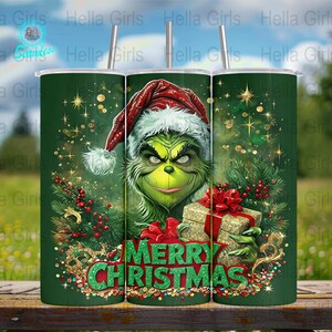 May include: A green tumbler featuring the Grinch wearing a Santa hat, holding a wrapped gift. The tumbler has the words "MERRY CHRISTMAS" in green and red. The design includes Christmas tree branches, berries, and gold accents.