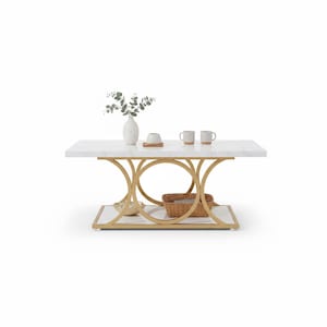 May include: A rectangular white marble-top coffee table with a gold-colored metal base. The base features a circular design and a lower shelf. The table is decorated with a vase, mugs, and a basket.