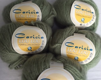 May include: Five balls of green yarn with labels that read "Caricia Lou Lou" and include washing instructions.