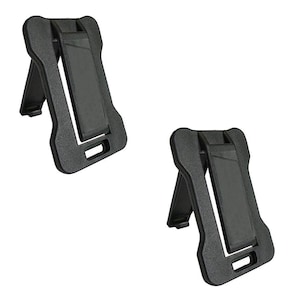 May include: Two black plastic phone stands. Each stand has a rectangular back with a slot for a phone and a hinged leg for support. The stands are designed to hold a phone upright.