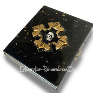 Baroque Cross with Skull Design Cigarette Case Inlaid in Hand Painted Black with Gold Splash Enamel with Personalized and Color Options