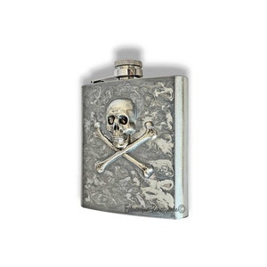 May include: Silver flask with a skull and crossbones design. The flask has a marbled pattern and a silver cap.