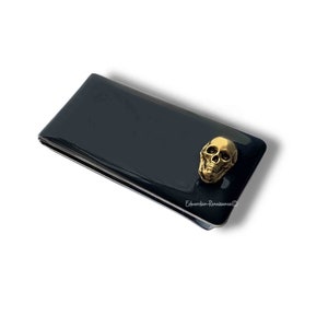 Clip para billetes con forma de calavera dorada antigua con incrustaciones de esmalte negro pintado a mano, estilo gótico victoriano, con opciones de color y personalización disponibles