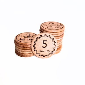 May include: Wooden screen time tokens with a natural finish. One token features a starburst edge with the number "5" and the word "minutes." Other tokens have a screen time icon. The tokens are stacked in piles.