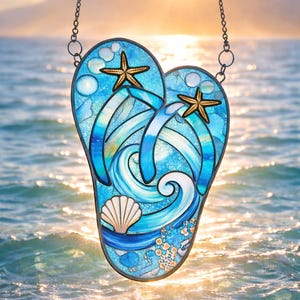 May include: Stained glass flip-flop design with a beach theme. The artwork features blue and white waves, a seashell, and two starfish. The flip-flop is suspended by a chain against a backdrop of the ocean and a setting sun.