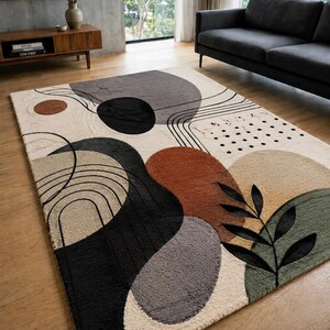 Puede incluir: Una alfombra rectangular con un dise&ntilde;o abstracto de formas org&aacute;nicas en tonos negro, gris, naranja &oacute;xido, beige y verde salvia. El patr&oacute;n incluye l&iacute;neas negras finas, un grupo de puntos peque&ntilde;os y un motivo de hoja de color negro.