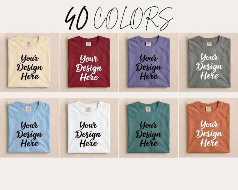 May include: A selection of folded t-shirts in various colors, each displaying the text "Your Design Here" in a bold, black font. The image is labeled "40 COLORS" at the top, showcasing a range of options for custom designs.