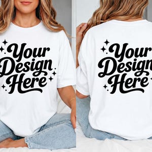 May include: White t-shirt with the text "Your Design Here" in a black, cursive font. The design is on the front and back of the shirt. The shirt is a casual style, suitable for custom designs.