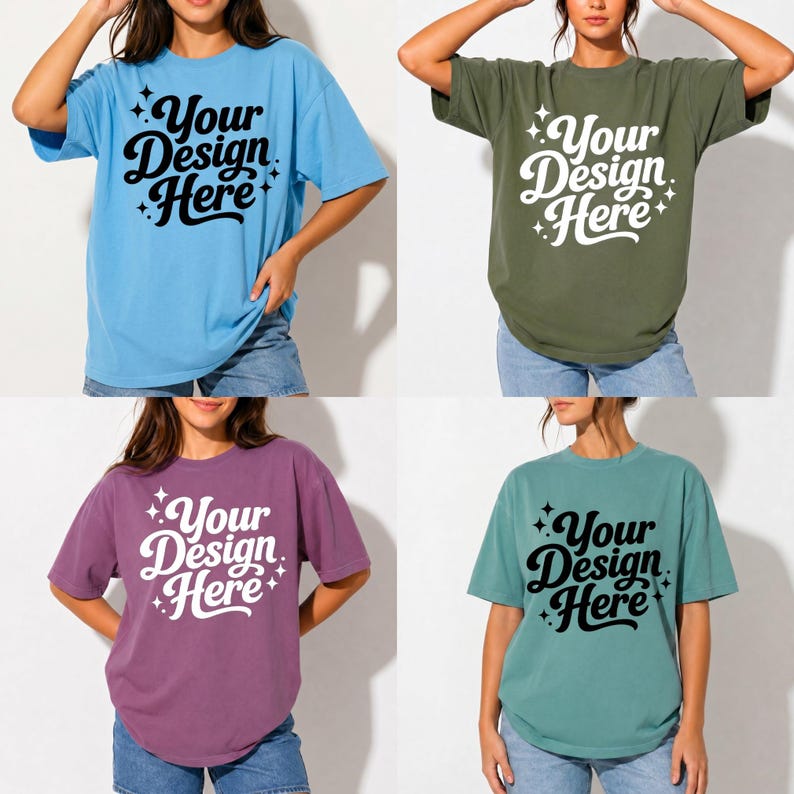 May include: Four short-sleeved t-shirts in different colors: light blue, olive green, purple, and teal. Each shirt has the text "Your Design Here" in a script font with star accents. The shirts are made of a soft material.