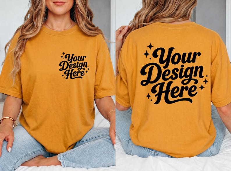 May include: Mustard yellow t-shirt with the text "Your Design Here" in black script on the front and back. The design is surrounded by small starbursts. The shirt is a casual, oversized fit.