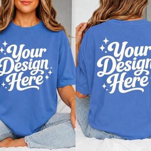 May include: A blue t-shirt with the text "Your Design Here" in white script. The design is on the front and back of the shirt. The shirt is a solid blue color.