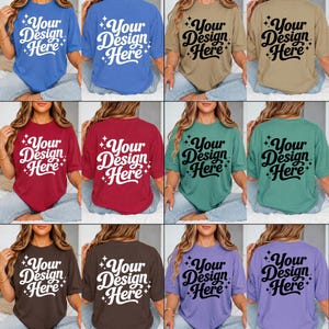 May include: A collection of eight short-sleeved t-shirts in various colors, including blue, tan, red, green, brown, and purple. Each shirt features the text "Your Design Here" in a stylized font on the front and back.