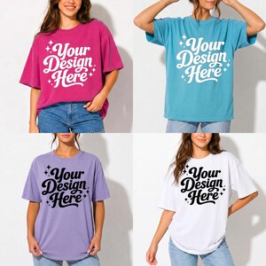 May include: Four oversized t-shirts in different colors: fuchsia, teal, lavender, and white. Each shirt has the text "Your Design Here" in a script font with star accents. The shirts are worn with blue jeans.