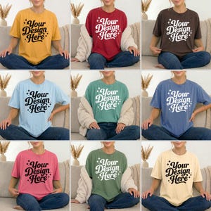 Pode incluir: Uma cole&ccedil;&atilde;o de nove camisetas de manga curta e gola redonda em v&aacute;rias cores s&oacute;lidas, incluindo amarelo, vermelho, marrom, azul claro, verde, azul, rosa, s&aacute;lvia e creme, com o texto preto Your Design Here e detalhes de estrelas.