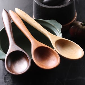 Handmade heirloom quality wooden stirring and mixing spoon hand hand-carved from Cherry wood, Maple wood, and Walnut wood.