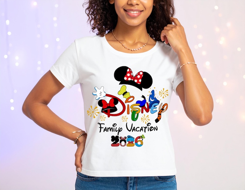May include: White t-shirt featuring a colorful Disney design with Mickey Mouse ears, the word "DISNEY", and the text "Family Vacation 2006". The design includes various character elements and accents.