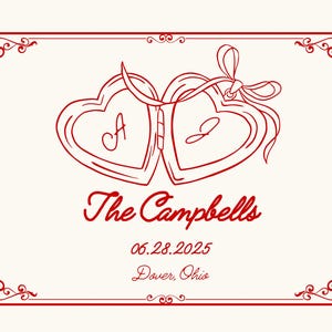 May include: Cream-colored card with a red border and decorative corner flourishes. Two connected heart-shaped lockets with the letters "A" and "J" are featured. The text "The Campbells", "06.28.2025", and "Dover, Ohio" are also included.