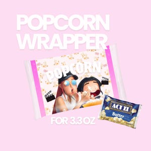May include: A pink popcorn wrapper with the text "POPOCORN WRAPPER" in white. The wrapper features an illustration of two people eating popcorn. A small bag of ACT II Butter popcorn is also visible. The wrapper is designed for 3.3 oz.