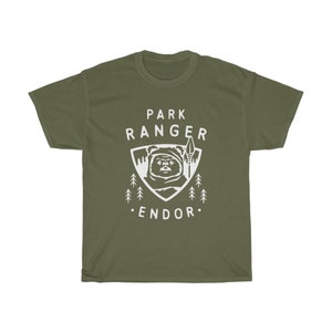 May include: A green t-shirt with a white graphic of a character from Star Wars, a forest, and the text "Park Ranger Endor".