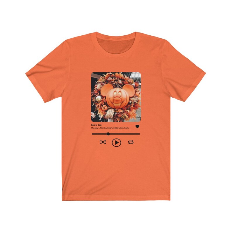 May include: Orange t-shirt with a graphic of a Mickey Mouse pumpkin on a music player screen. The text on the screen reads "Boo to You" and "Mickey's Not So Scary Halloween Party".