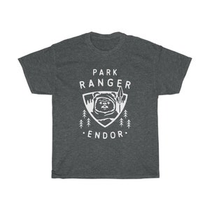 May include: Dark heather grey t-shirt with a white graphic of a character from Star Wars, a white triangle with the text "Park Ranger Endor" and trees.