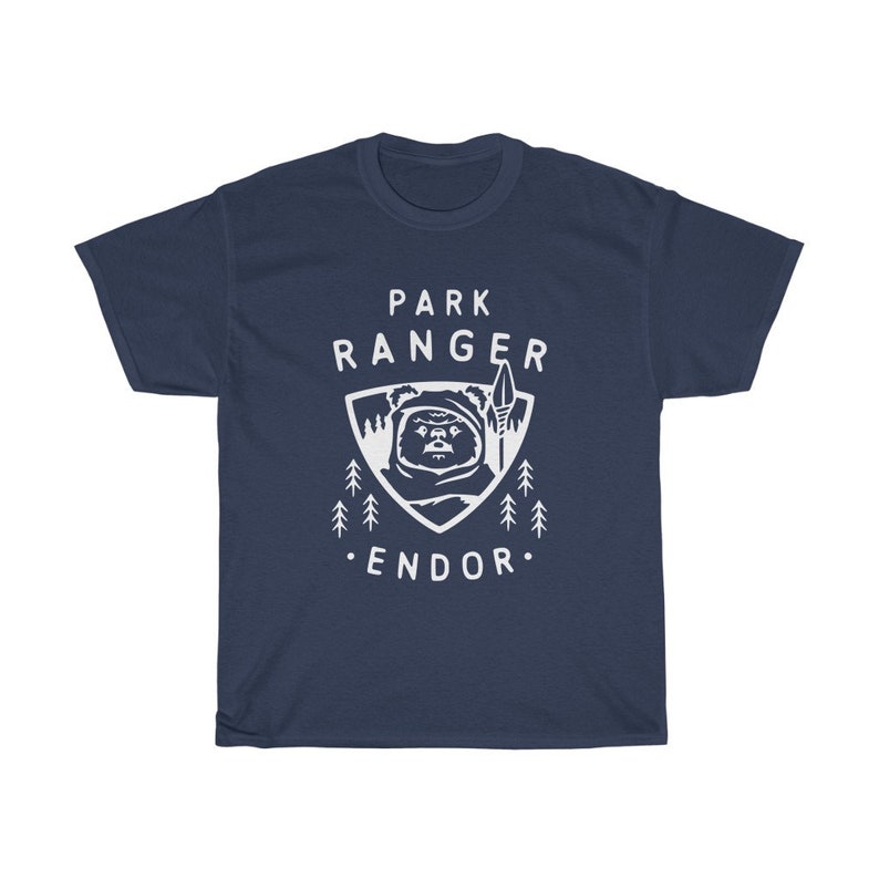 May include: A navy blue t-shirt with a white graphic of a character from Star Wars, a spear, and trees. The text "Park Ranger Endor" is printed on the shirt.