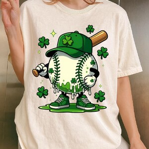 May include: A cartoon baseball character wearing a green baseball cap with a shamrock, green trainers, and holding a baseball bat. The baseball has shamrocks and green slime dripping down. Green shamrocks and stars are scattered around.