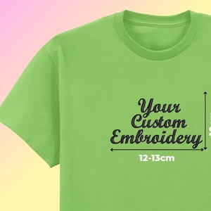 May include: A lime green t-shirt with the text "Your Custom Embroidery" in a script font. The embroidery area is approximately 10cm high and 12-13cm wide. The shirt is displayed against a gradient background.