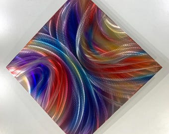 May include: Abstract metal wall art featuring swirling lines in shades of red, blue, purple, and gold.