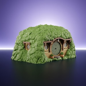 May include: A miniature earth-sheltered dwelling featuring a textured green grassy exterior, a round olive green door with a central knob, two small round windows with lattice detailing, and a brick-patterned facade with two potted plants.